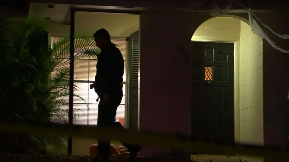 PHOTO: A man walks around a home in Seminole County, Fla., where authorities say a man was stabbed to death by his former roommates on Nov. 27, 2018.