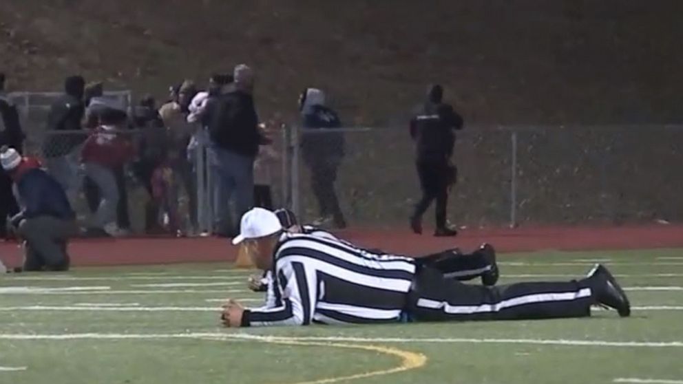 PHOTO: Referees and players take cover after shots were fired at a high school football game in Pleasantville, New Jersey, Nov. 15, 2019.