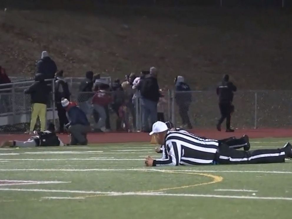 PHOTO: Referees and players take cover after shots were fired at a high school football game in Pleasantville, New Jersey, Nov. 15, 2019.