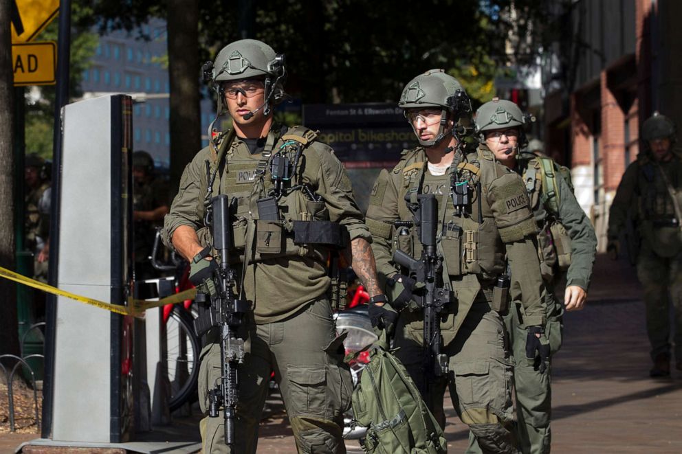 PHOTO: Montgomery police officers in tactical gear exit a parking garage where a police officer was shot, in Silver Spring, Md., Oct. 14, 2019. 