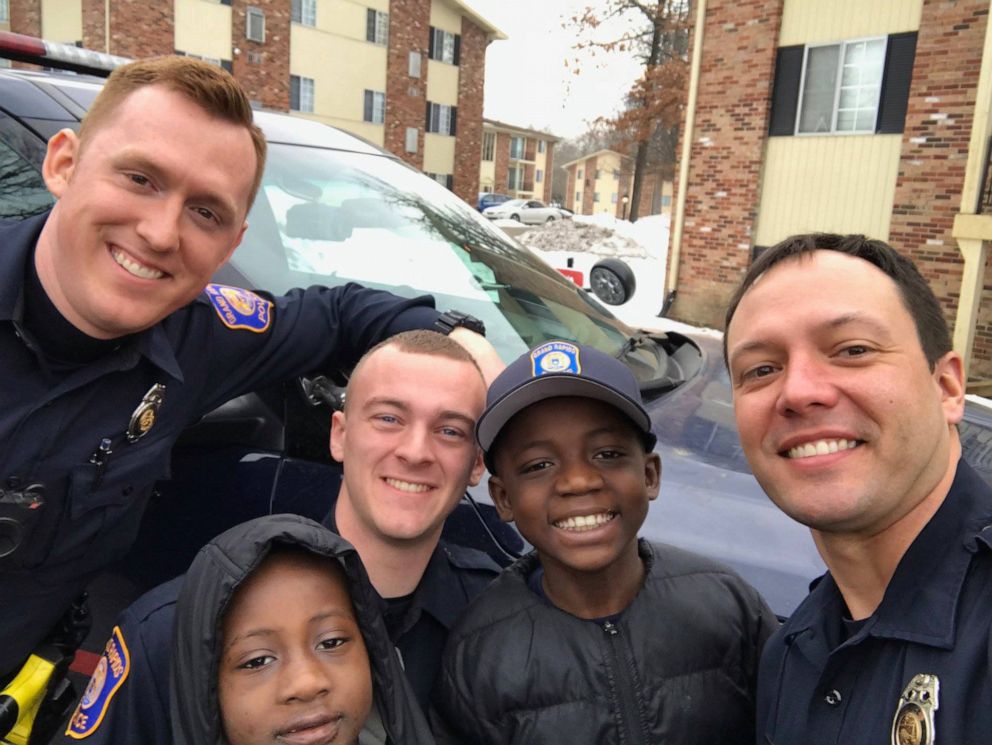 Officers from the Grand Rapids Police Department help celebrate 9-year-old Thomas Daniel's birthday. 