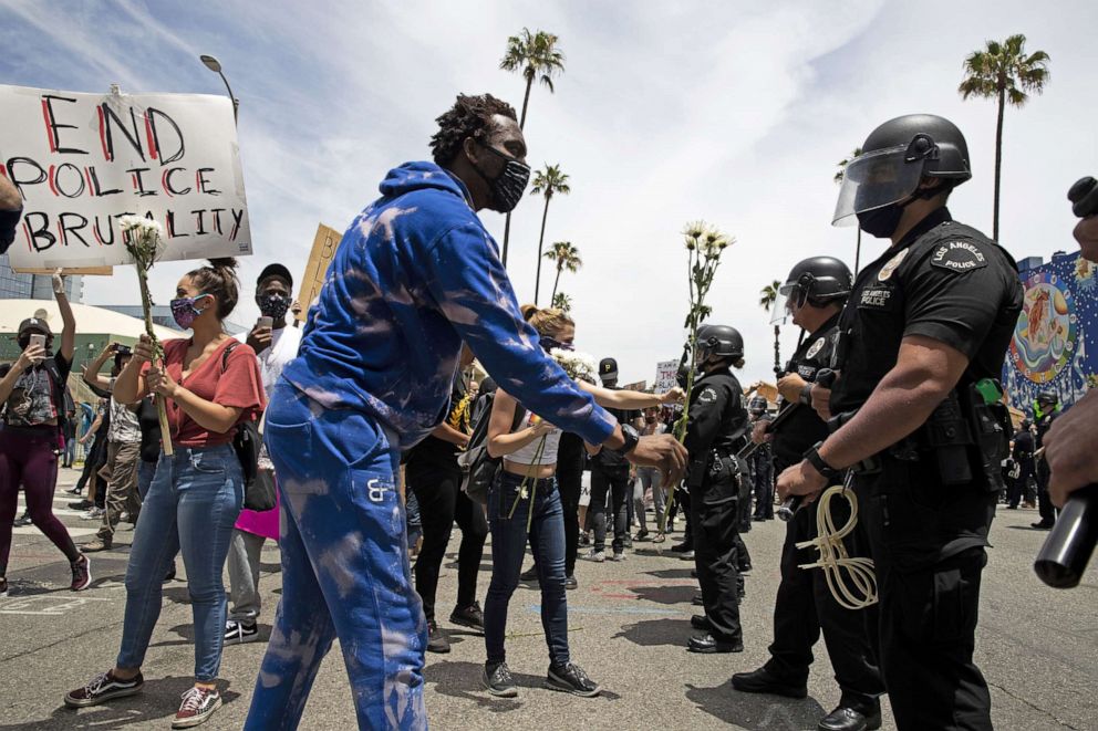 PHOTO: Demonstrators talk to members of the LAPD during a march in response to George Floyd's death on June 2, 2020, in Los Angeles.