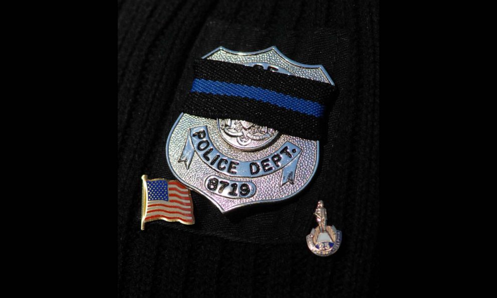 PHOTO: In this Nov. 7, 2007, file photo, a police officer wears a black ribbon on his badge at the funeral for a fellow officer in Philadelphia.