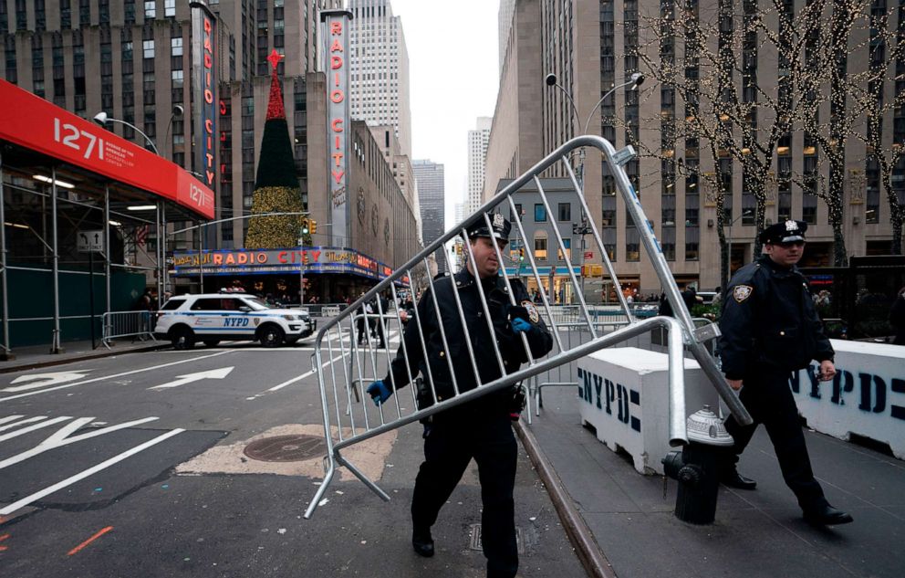 PHOTO: Police officers move barricades on Dec. 31, 2018 near Times Square in New York.