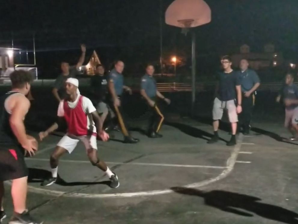 PHOTO: Pompton Lakes (NJ) police officers join in a pick-up basketball game between local youths, Sept. 23, 2019.