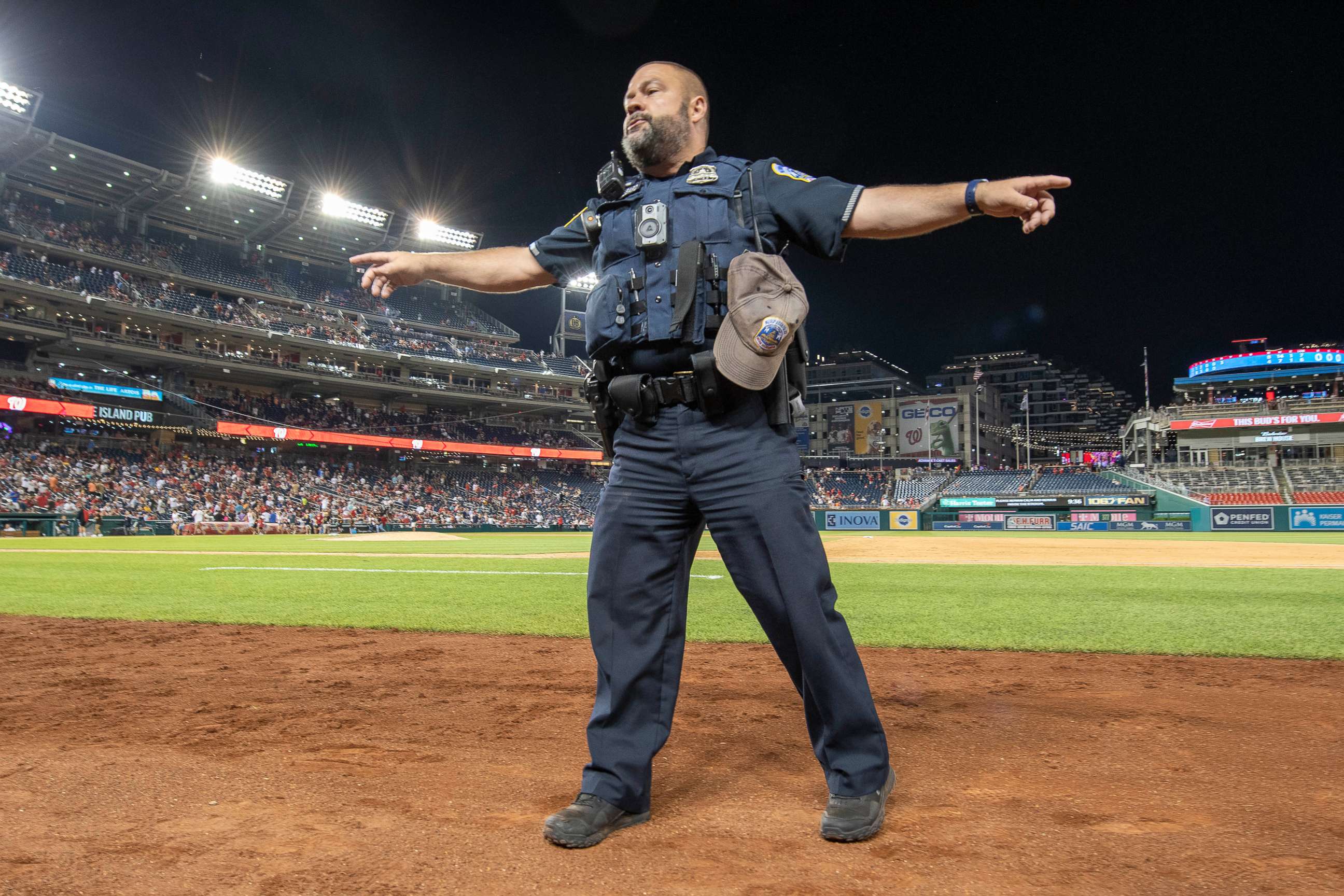 PHOTO: A policeman directs fans after apparent gunshots were heard outside of Nationals Park during a game between the Washington Nationals and the San Diego Padres. 