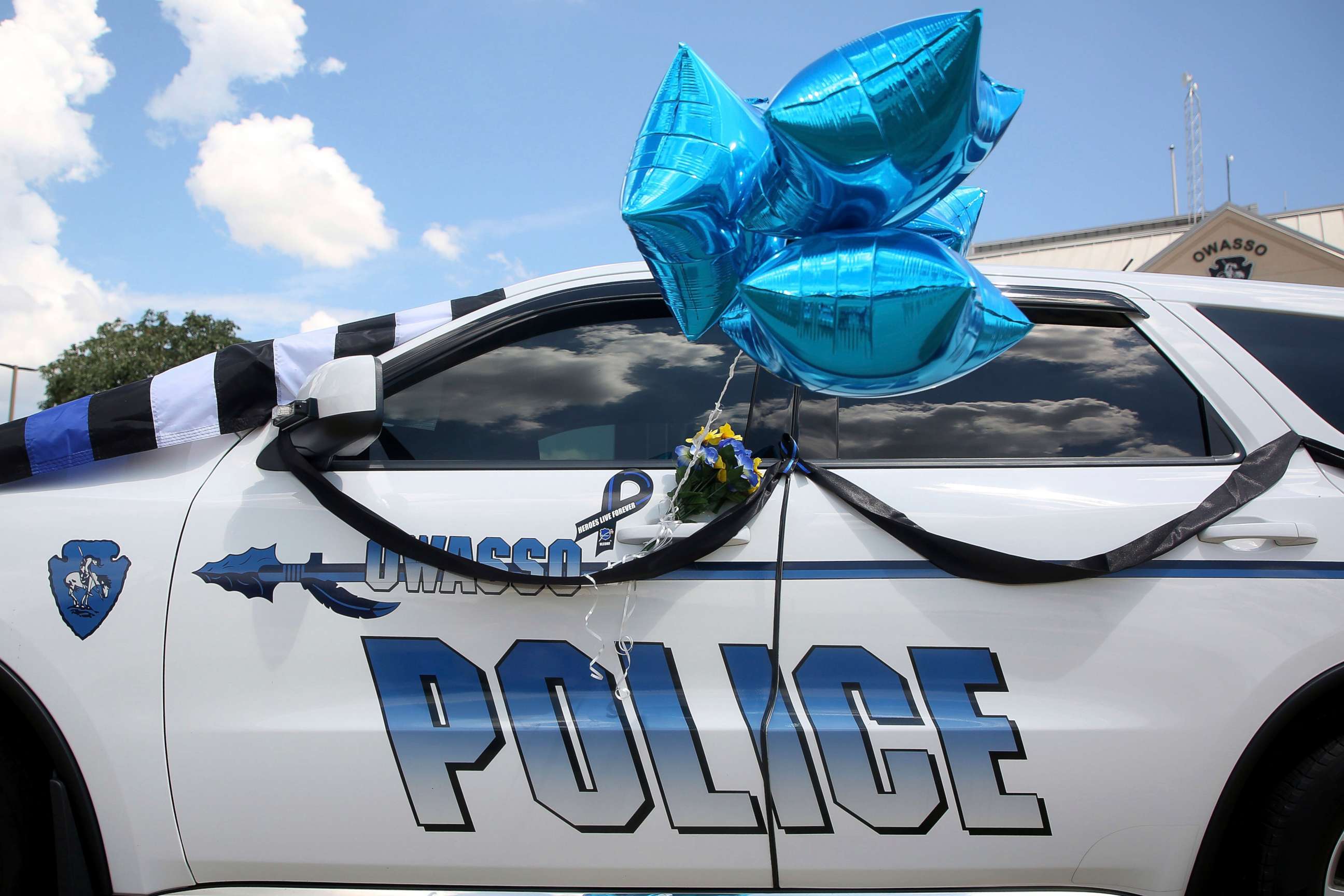PHOTO: The patrol car of Owasso Police Officer Edgar "Buddy" Pales is turned into a makeshift memorial in front of the Owasso Police Department headquarters, Aug. 30, 2021, in Owasso, Okla.