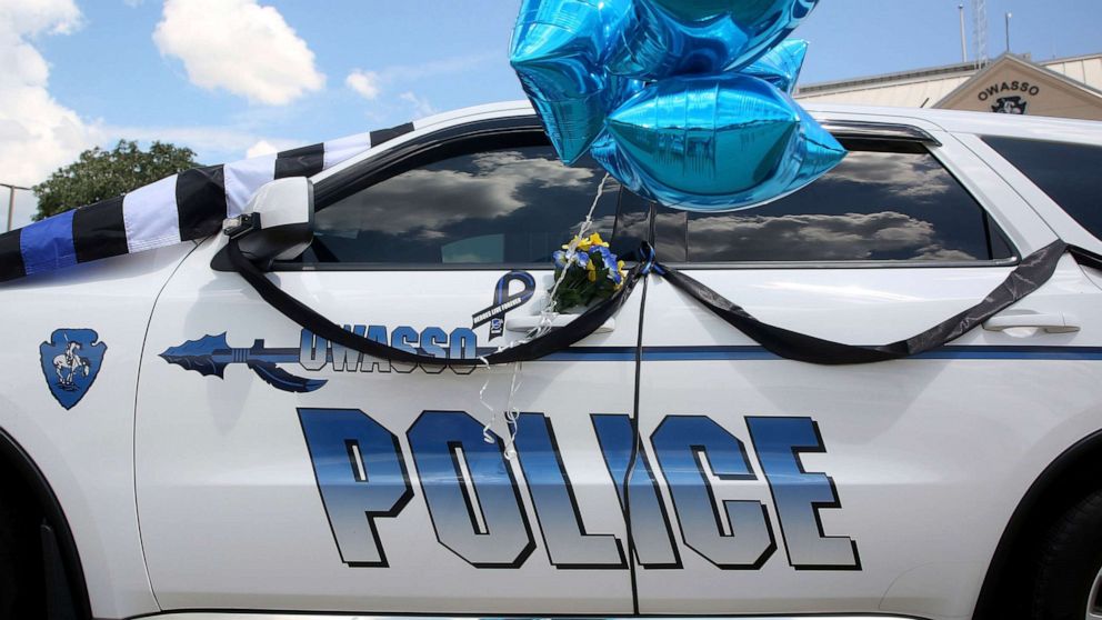 PHOTO: The patrol car of Owasso Police Officer Edgar "Buddy" Pales is turned into a makeshift memorial in front of the Owasso Police Department headquarters, Aug. 30, 2021, in Owasso, Okla.