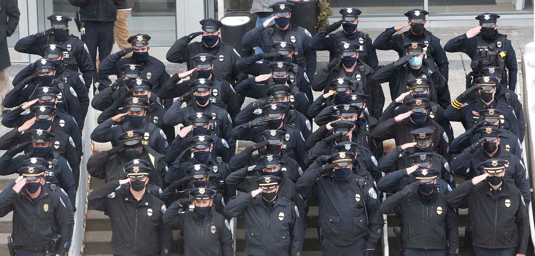 PHOTO: Members of the Akron Police Department salute the funeral motorcade of Akron Police Officer Edward Stewart in front of the Harold K. Stubbs Justice Center, Feb. 20, 2021, in Akron, Ohio.