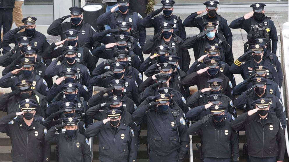 PHOTO: Members of the Akron Police Department salute the funeral motorcade of Akron Police Officer Edward Stewart in front of the Harold K. Stubbs Justice Center, Feb. 20, 2021, in Akron, Ohio.
