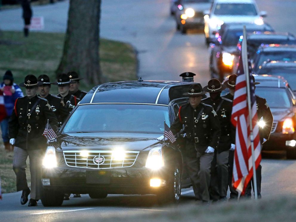 PHOTO: The honor guard walks along the hearse carrying the casket of Boone County Sheriffs Deputy Jacob Pickett, March 9, 2018, in Indianapolis. Pickett was fatally shot March 2, 2018, while chasing a man fleeing from police.