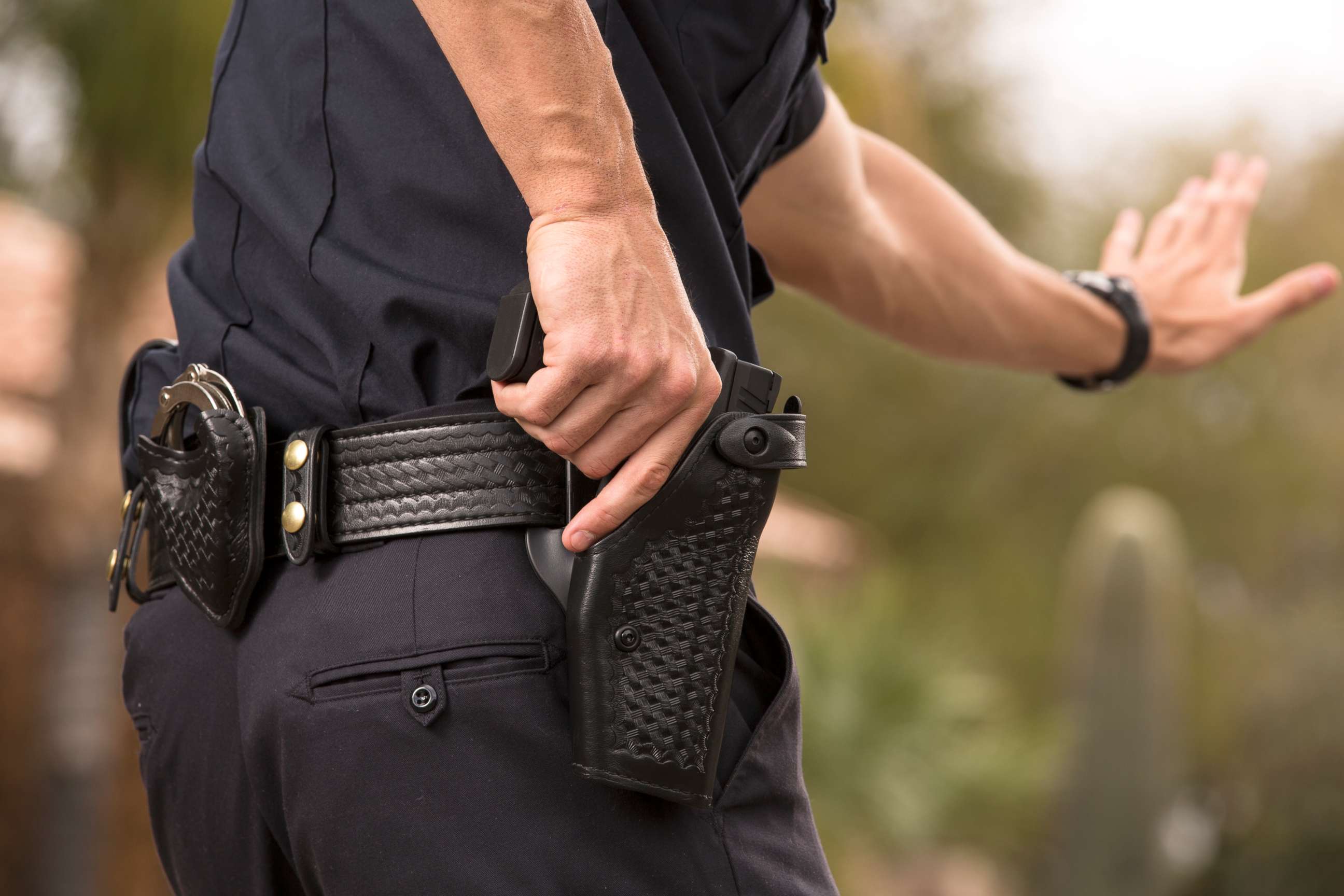 PHOTO: A Policeman preparing to draw his gun in a stock photo.