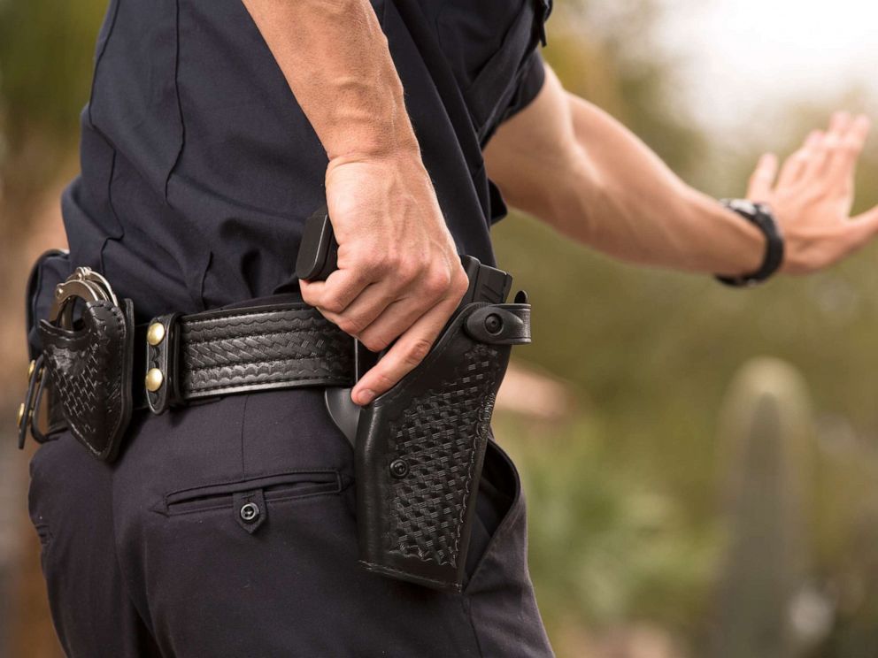 PHOTO: A Policeman preparing to draw his gun in a stock photo.
