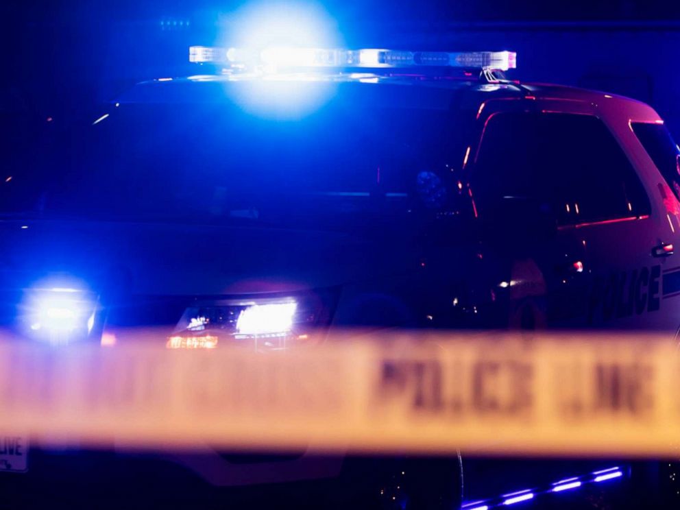 PHOTO: Police officers, tape, cruiser.