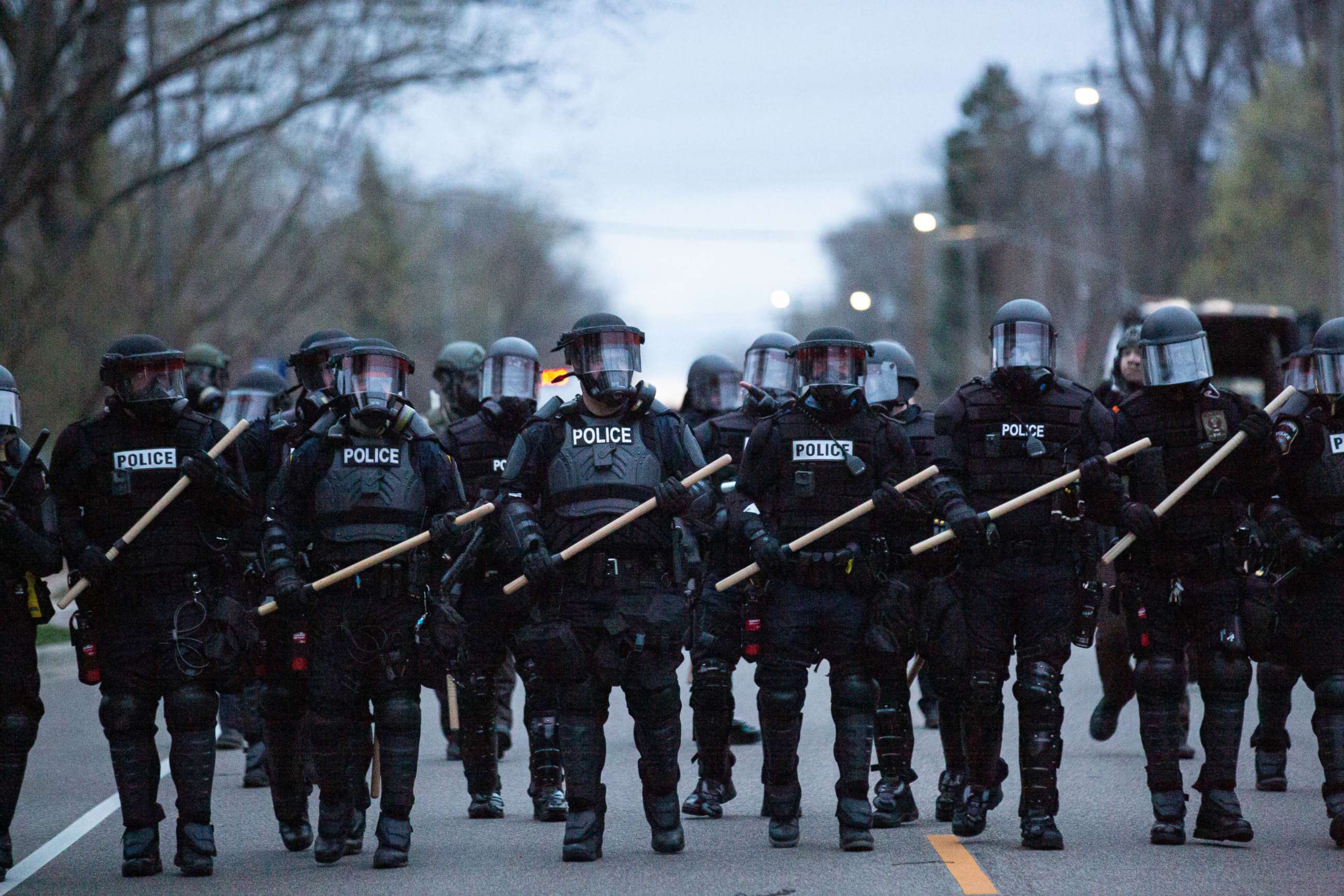 PHOTO: Minneapolis police officers stand in line as they are confronted by protesters after an officer shot and killed a black man in Brooklyn Center, Minneapolis, Minn. on April 11,2021.
