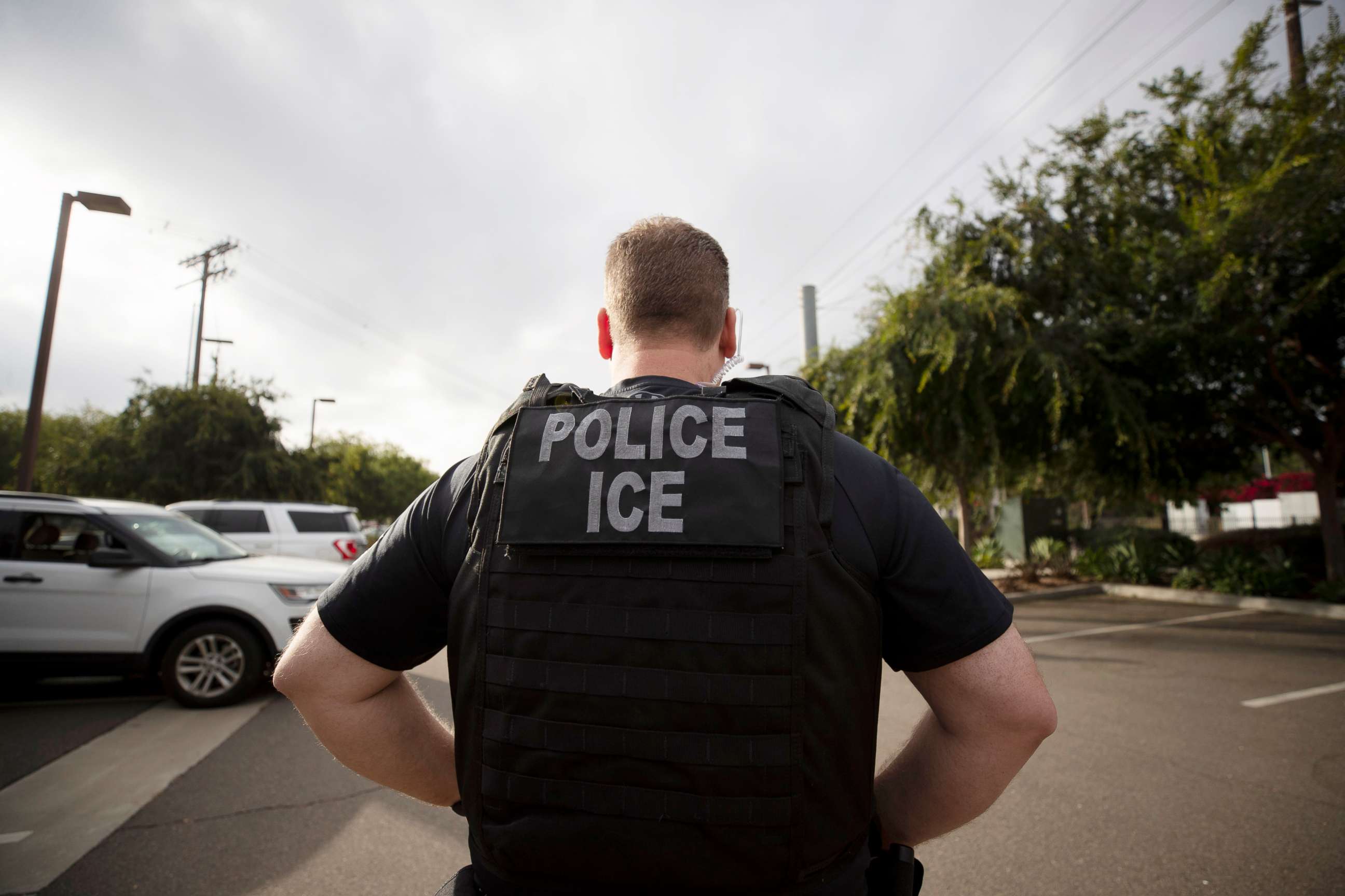 PHOTO: In this July 8, 2019, file photo, a U.S. Immigration and Customs Enforcement (ICE) officer looks on during an operation in Escondido, Calif. 
