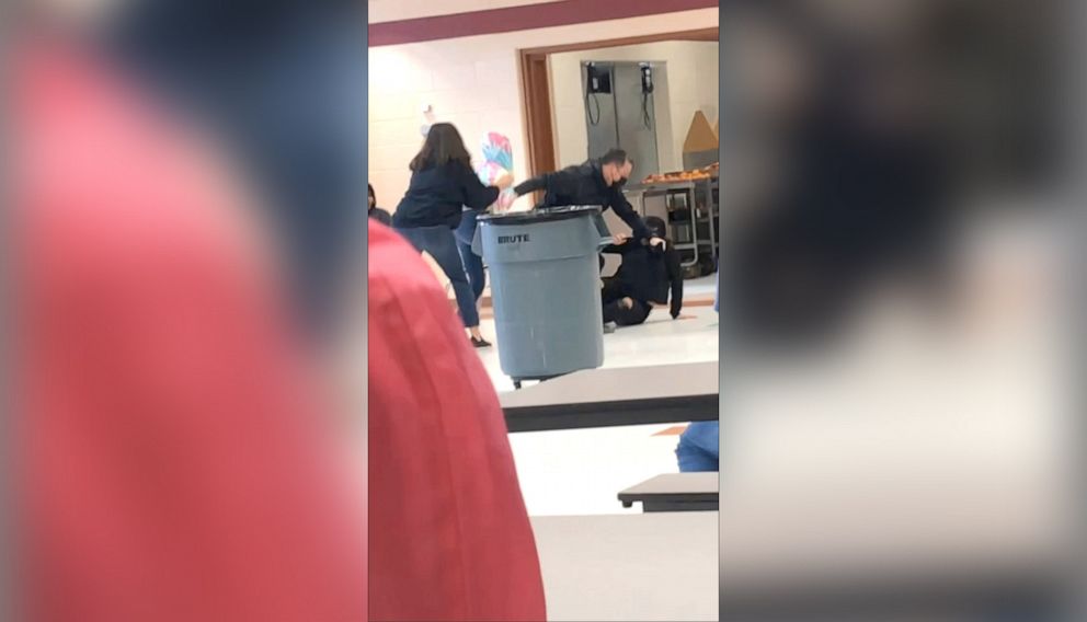 PHOTO: An off-duty police officer responds to a fight between two students at Lincoln Middle School in Kenosha, Wis., on March 4, 2022, in a still image from video. The officer appeared to kneel on the neck of a student, prompting an investigation.