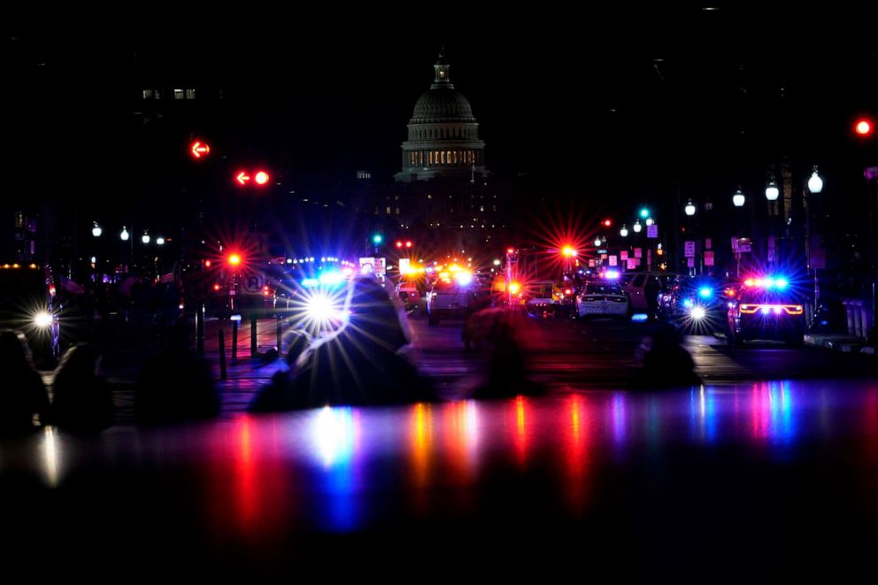 PHOTO: Lights from police vehicles illuminate Pennsylvania Avenue with the U.S. Capitol building in the background in Washington, D.C., on Jan. 6, 20201.