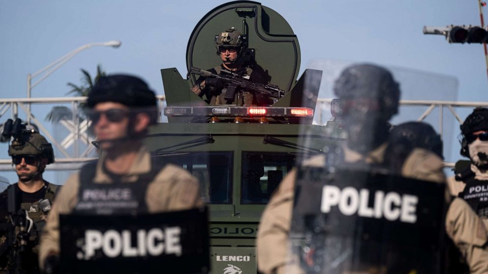 PHOTO: A Miami Police officer watches protestors from a armored vehicle during a rally in response to the recent death of George Floyd in Miami on May 31, 2020.