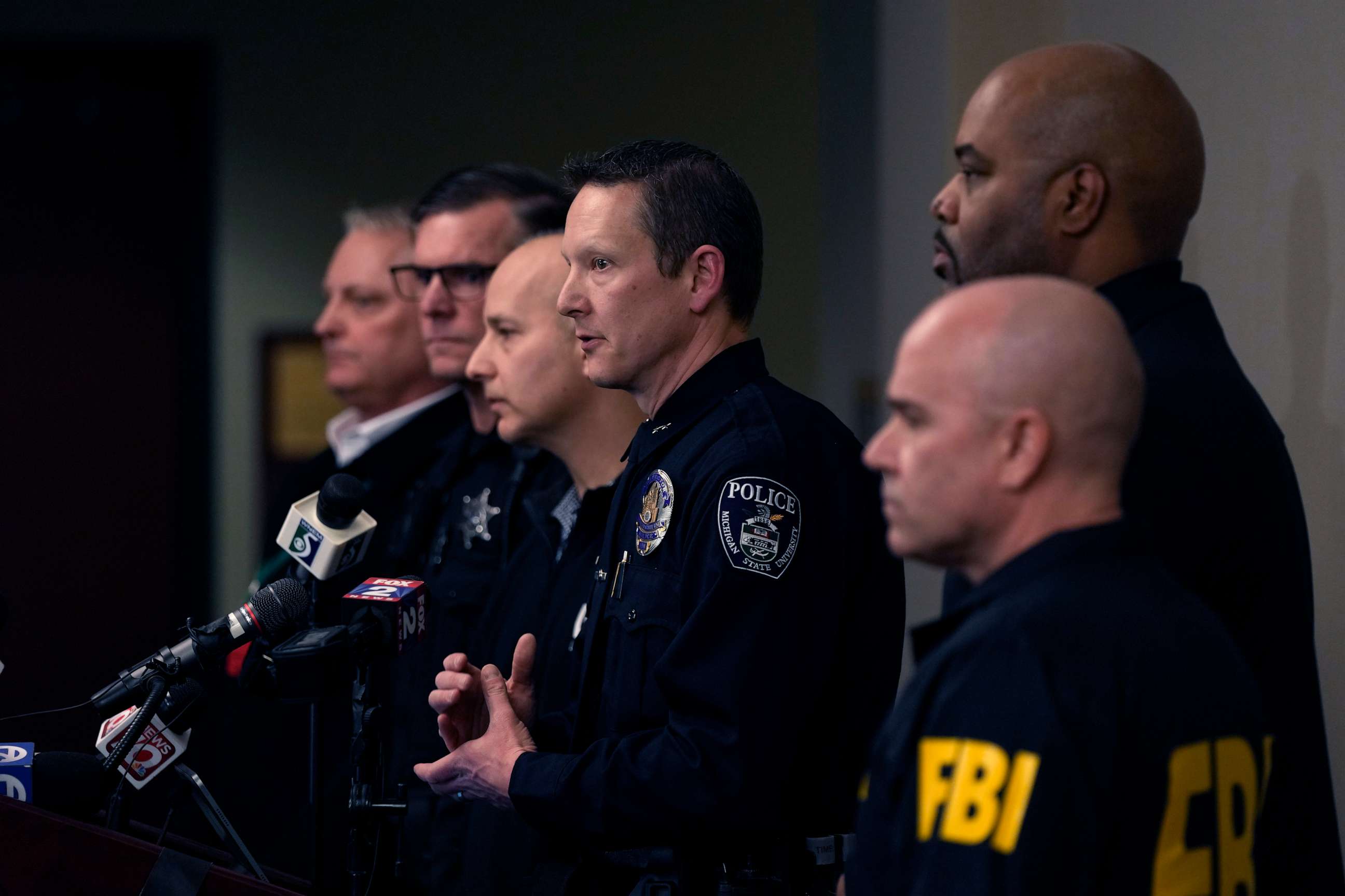 PHOTO: Michigan State University Interim Deputy Police Chief Chris Rozman, center, joins law enforcement officials while addressing the media, Tuesday, Feb. 14, 2023, in East Lansing, Michigan.