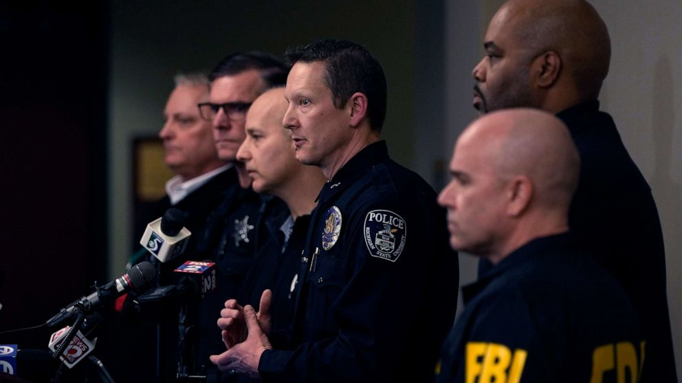 PHOTO: Michigan State University Interim Deputy Police Chief Chris Rozman, center, joins law enforcement officials while addressing the media, Tuesday, Feb. 14, 2023, in East Lansing, Michigan.