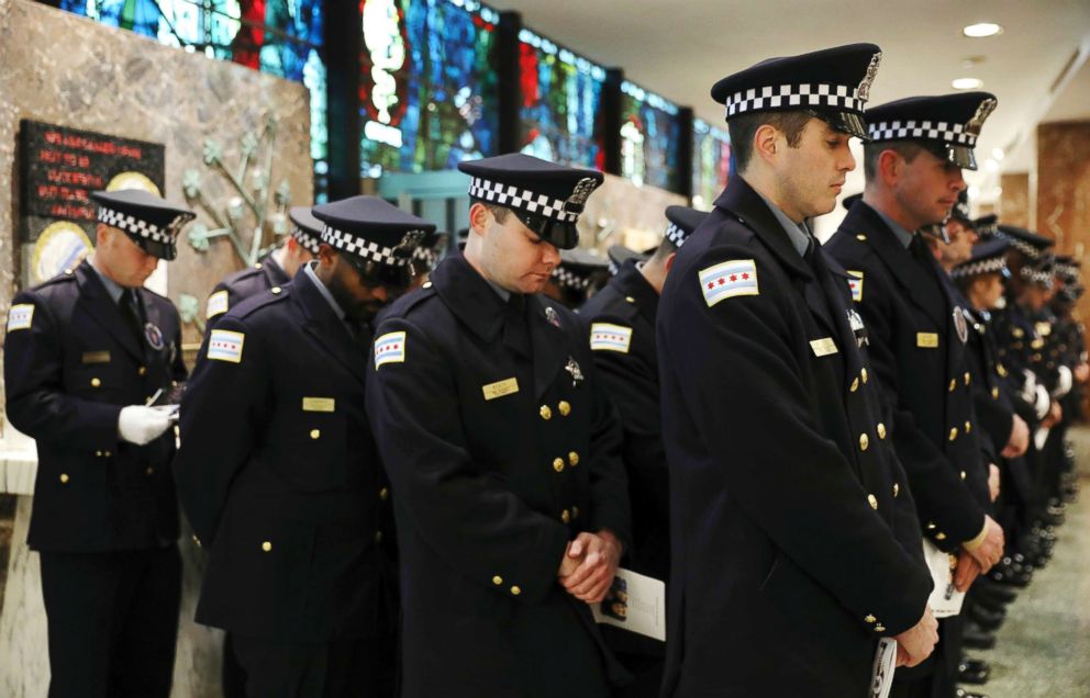 PHOTO: Police officers bow their heads during the funeral for Chicago police Officer Conrad Gary at St. Rita of Cascia Shrine Chapel in Chicago, Dec. 21, 2018.