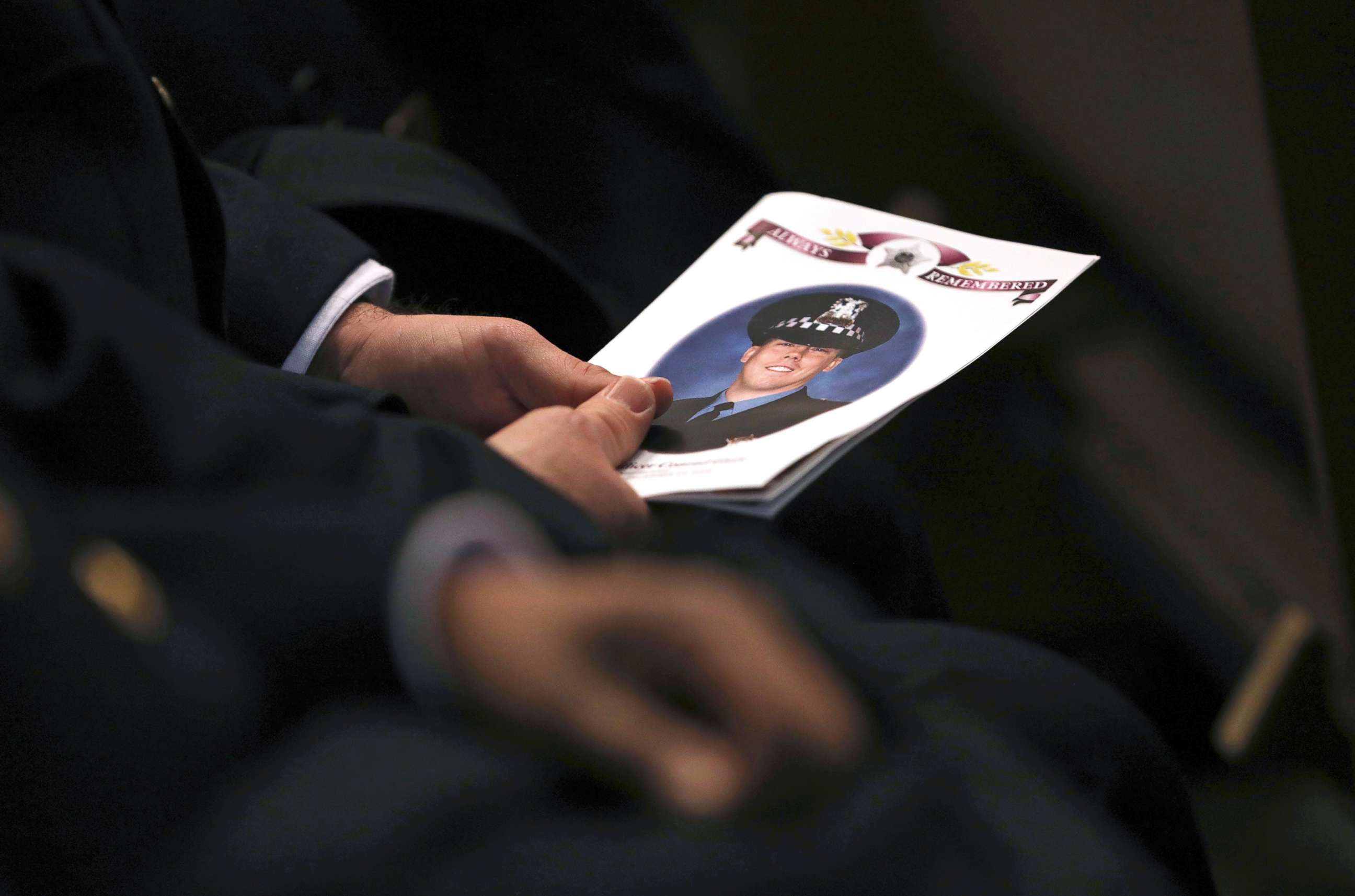 PHOTO: An attendee holds a program as police officers attend the funeral for Chicago police Officer Conrad Gary at St. Rita of Cascia Shrine Chapel in Chicago, Dec. 21, 2018.