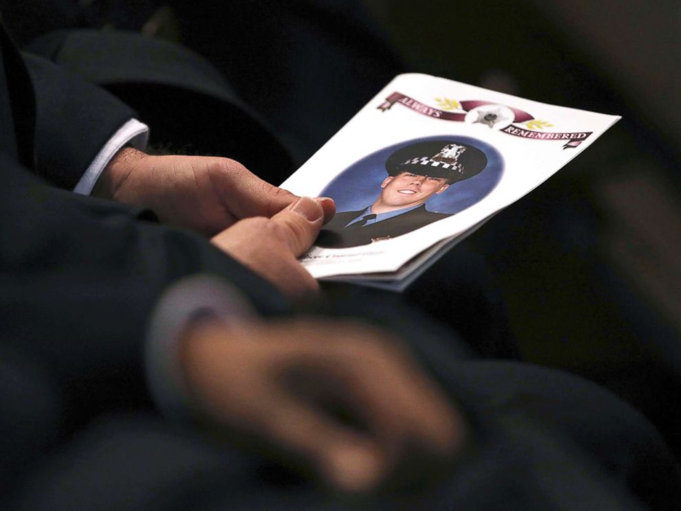 PHOTO: An attendee holds a program as police officers attend the funeral for Chicago police Officer Conrad Gary at St. Rita of Cascia Shrine Chapel in Chicago, Dec. 21, 2018.