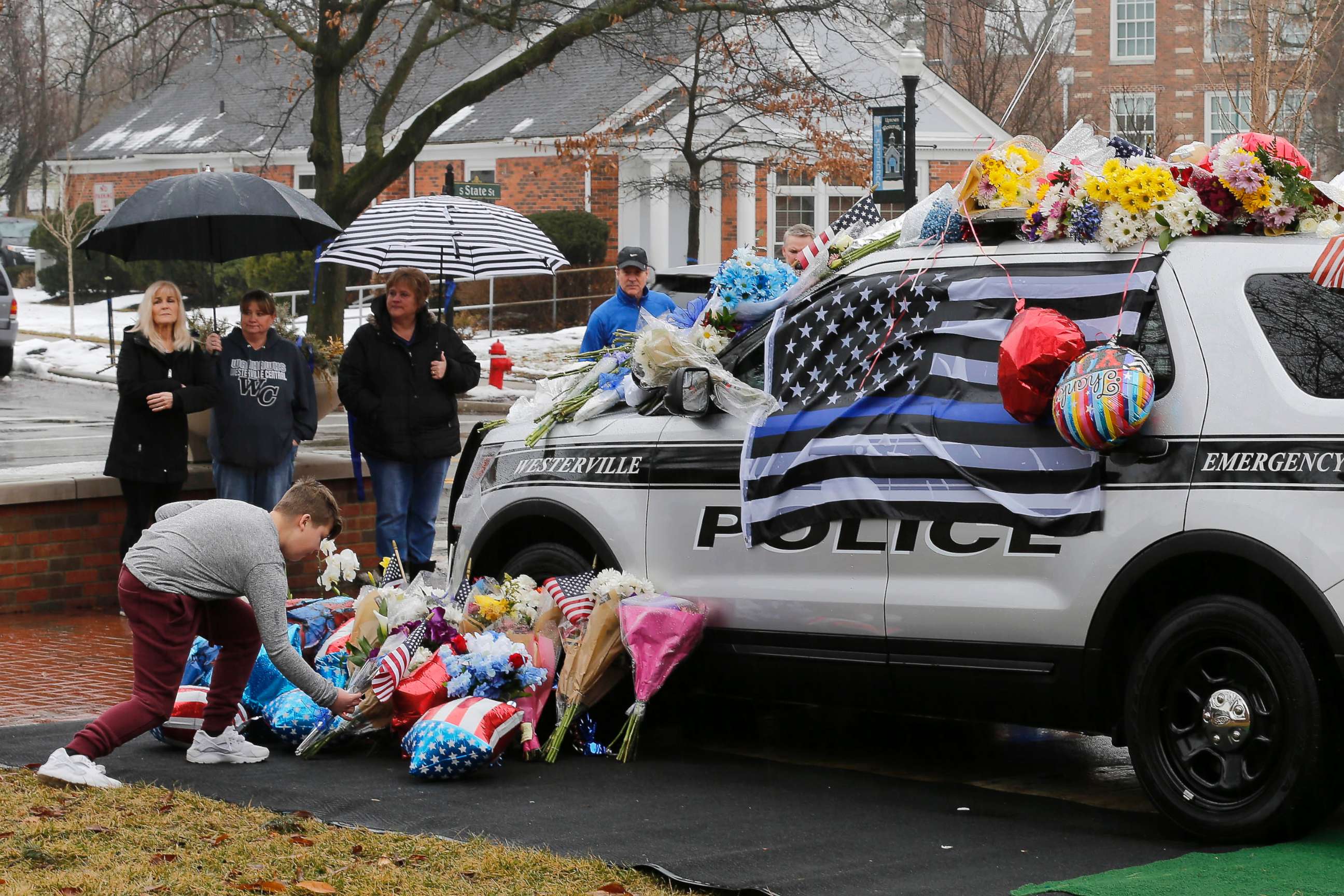 PHOTO: Mourners leave flowers on a police cruiser parked in front of City Hall in Westerville, Ohio, on Feb. 11, 2018. Westerville police officers Anthony Morelli and Eric Joering were killed in the line of duty on Feb. 10, 2018.