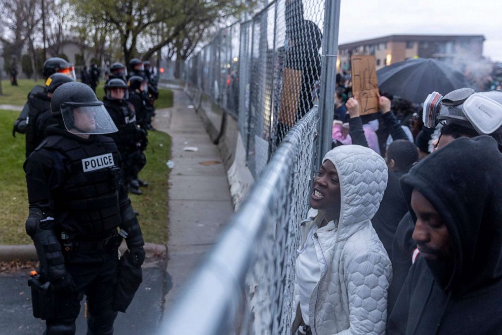 PHOTO: People shout toward police at the start of curfew to protest the officer-involved shooting death of Daunte Wright in Brooklyn Center, Minnesota, on April 12, 2021.