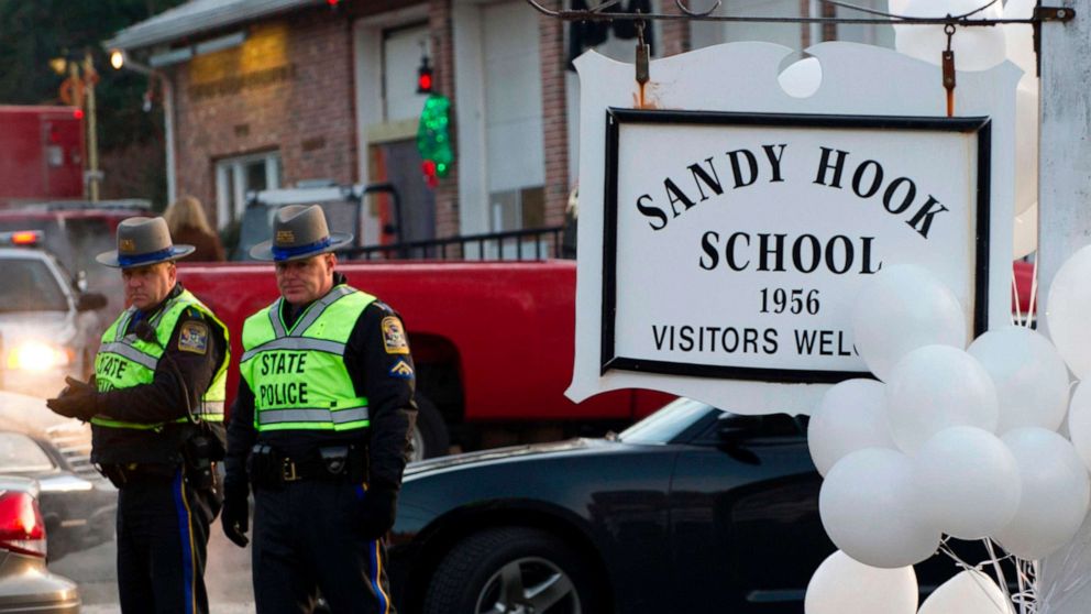 PHOTO: In this Dec. 15, 2012, file photo,, police stand guard at the entrance after a mass shooting at the Sandy Hook School in Newtown, Conn.