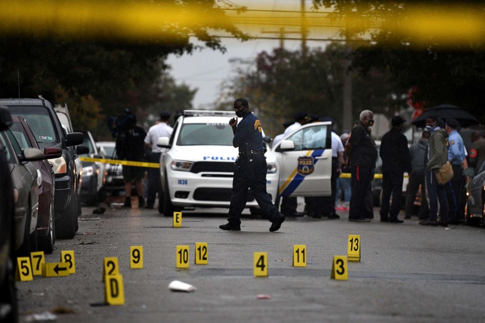 PHOTO: People stand near the scene of a police shooting in Philadelphia, Oct. 26, 2020. 