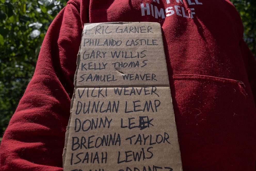 PHOTO: The names of Black men and women who have been killed by police are seen written on a piece of cardboard during a Black gun owners march to the governor's mansion in Oklahoma City, Okla., June 20, 2020.