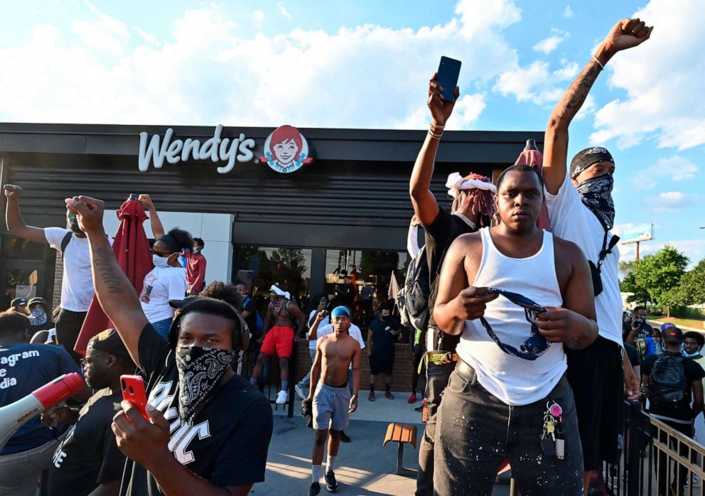 PHOTO: Protesters demonstrate outside a Wendy's restaurant in Atlanta, Saturday, June 13, 2020, where Rayshard Brooks, a black man, was shot and killed by Atlanta police Friday evening following a struggle in the drive-thru line.