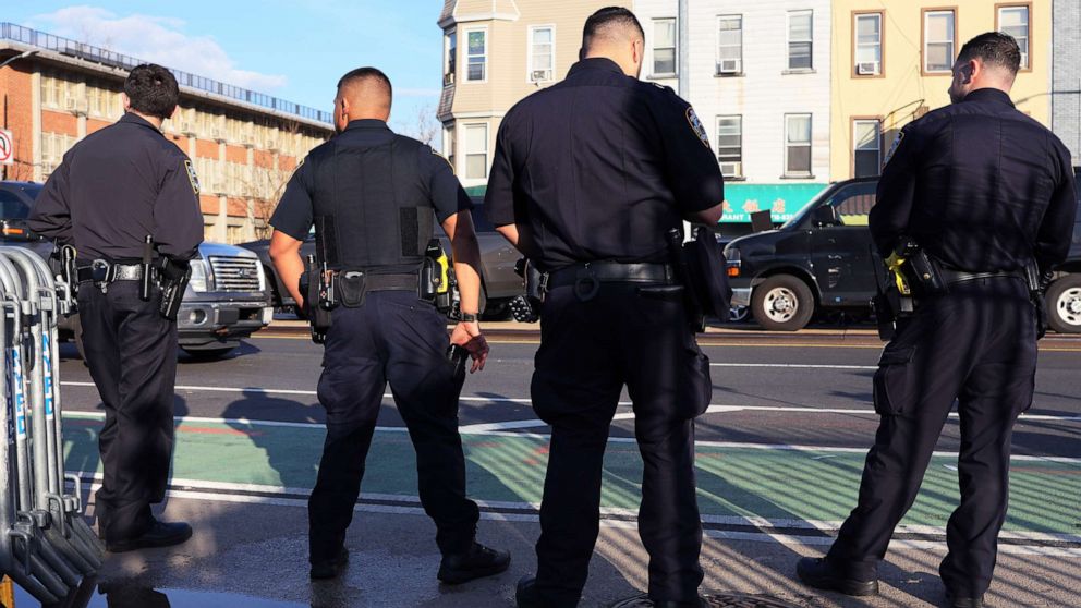 PHOTO: NYPD officers stand guard near the 36th Street subway station on April 13, 2022 in the Sunset Park neighborhood of Brooklyn in New York City. A manhunt is underway for a gunman who shot 10 people in the subway the previous day.