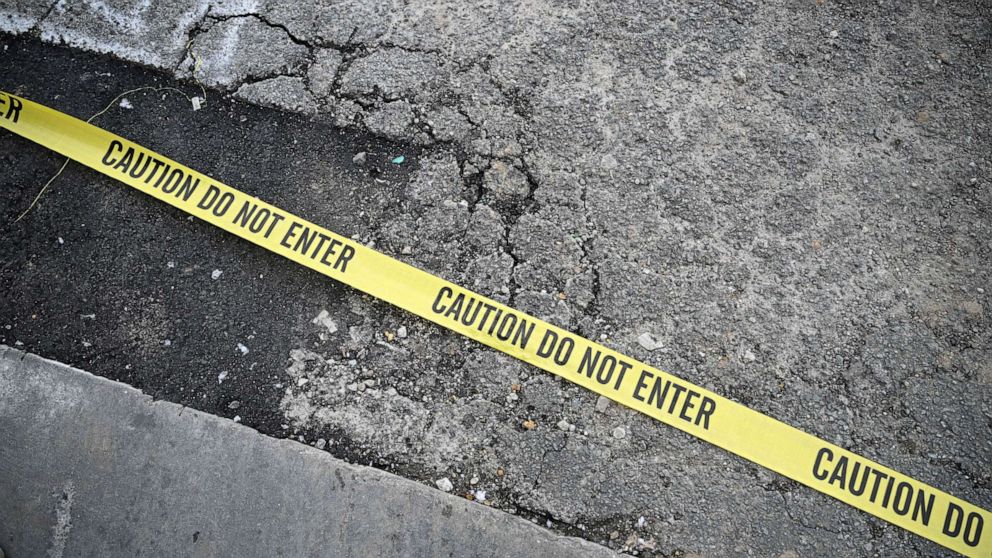 PHOTO: TOPSHOT - Police tape is seen on the ground in Monterey Park, California, on January 22, 2023.