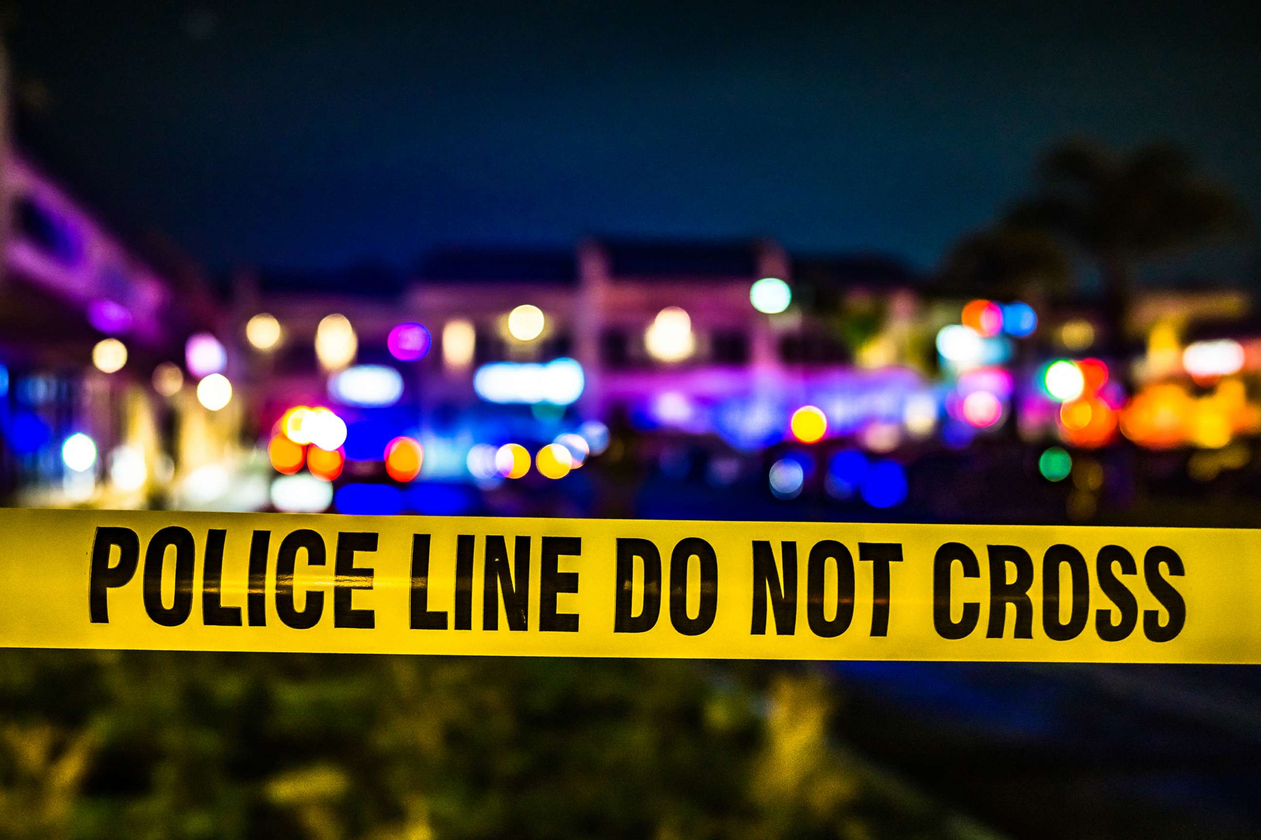 PHOTO: police line yellow tape marking crime scene at night