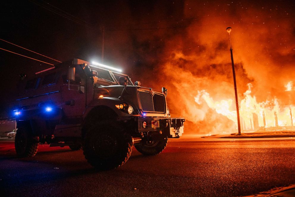PHOTO: A police armored vehicle patrols an intersection on Aug. 24, 2020, in Kenosha, Wis., during a second night of rioting after the shooting of Jacob Blake, 29, on August 23.
