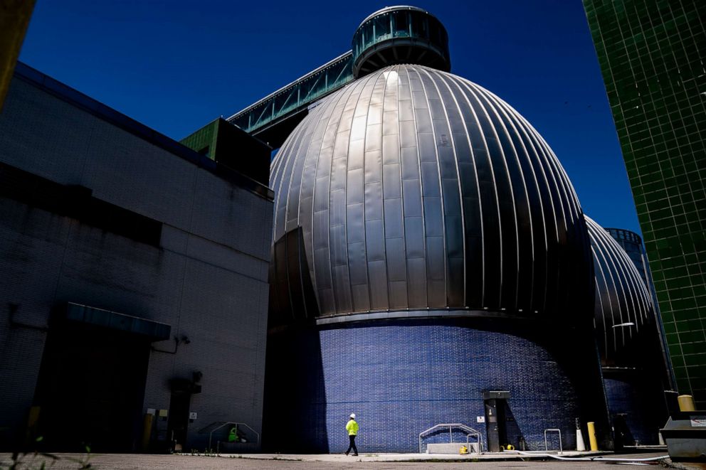 PHOTO: A worker walks alongside the Newtown Creek Wastewater Treatment Plant's array of digester eggs, Aug. 12, 2022, in New York City. 