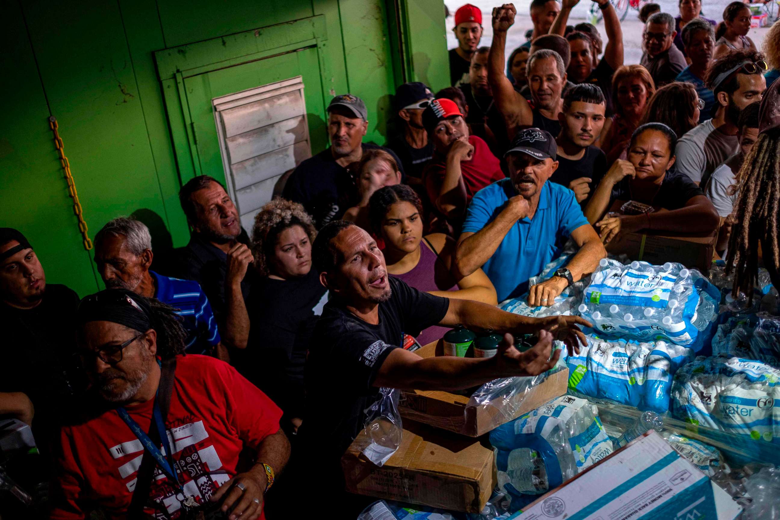 PHOTO: People break into a warehouse with supplies believed to have been from when Hurricane Maria struck the island in 2017 in Ponce, Puerto Rico on Jan. 18, 2020.
