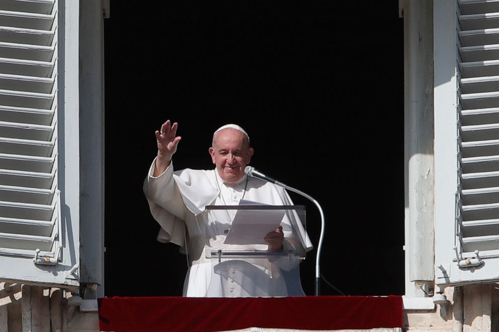 PHOTO: Pope Francis waves at the end of his Angelus noon prayer from the window of his studio overlooking St.Peter's Square, at the Vatican, Oct. 25, 2020.