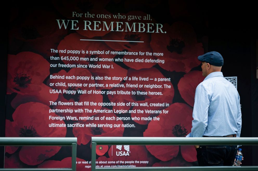 PHOTO: A visitor admires the USAA Poppy Wall of Honor, at the National Mall on May 27, 2022, in Washington, D.C.