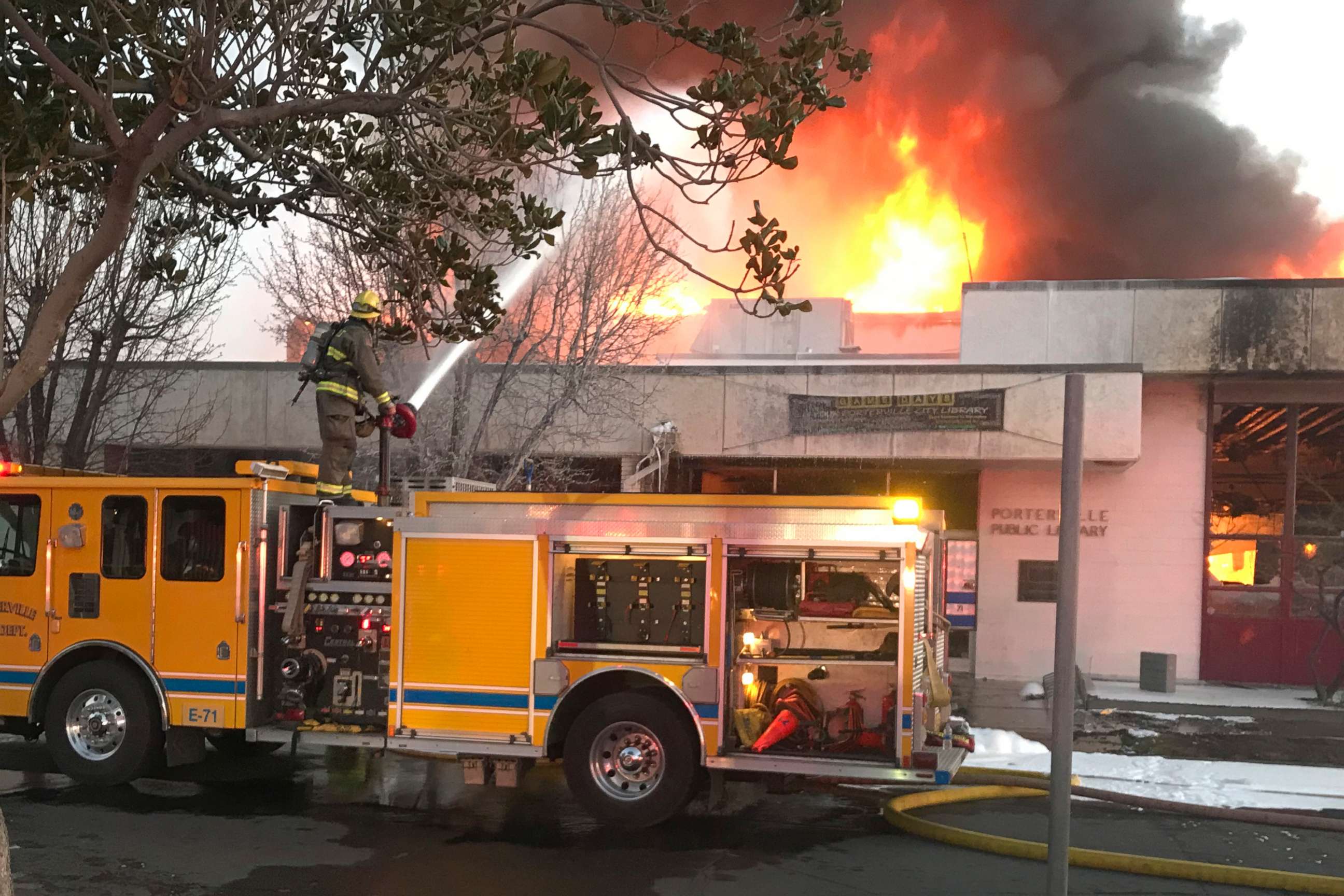 PHOTO: In this Tuesday, Feb. 18, 2020 photo, firemen battle a fire at the public library in Porterville, Calif.