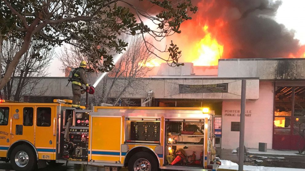 PHOTO: In this Tuesday, Feb. 18, 2020 photo, firemen battle a fire at the public library in Porterville, Calif.