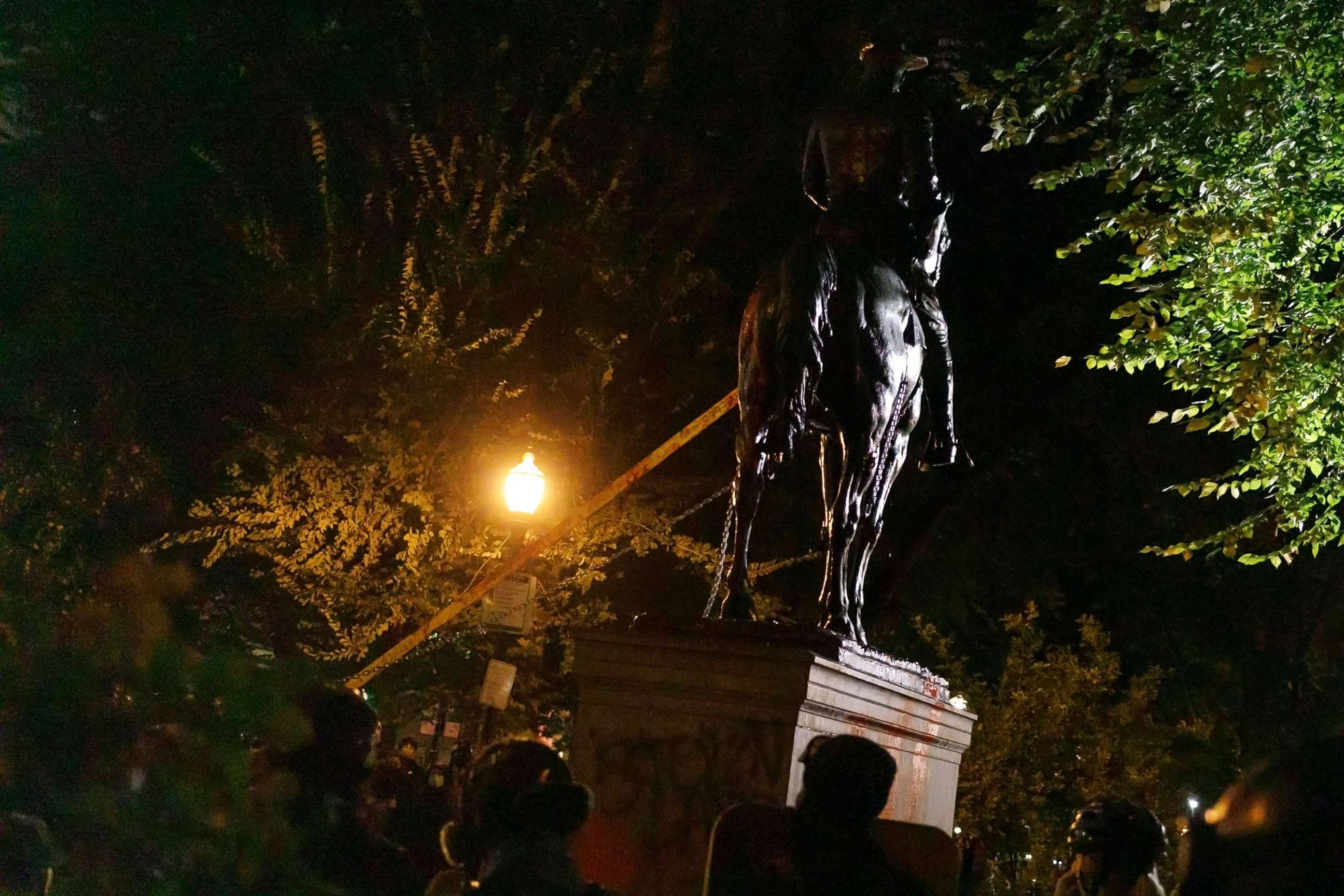 PHOTO: A statue of President Theodore Roosevelt is pulled down by demonstrators protesting white colonialism on a "Day of Rage" march in downtown Portland, Ore., Oct. 11, 2020.