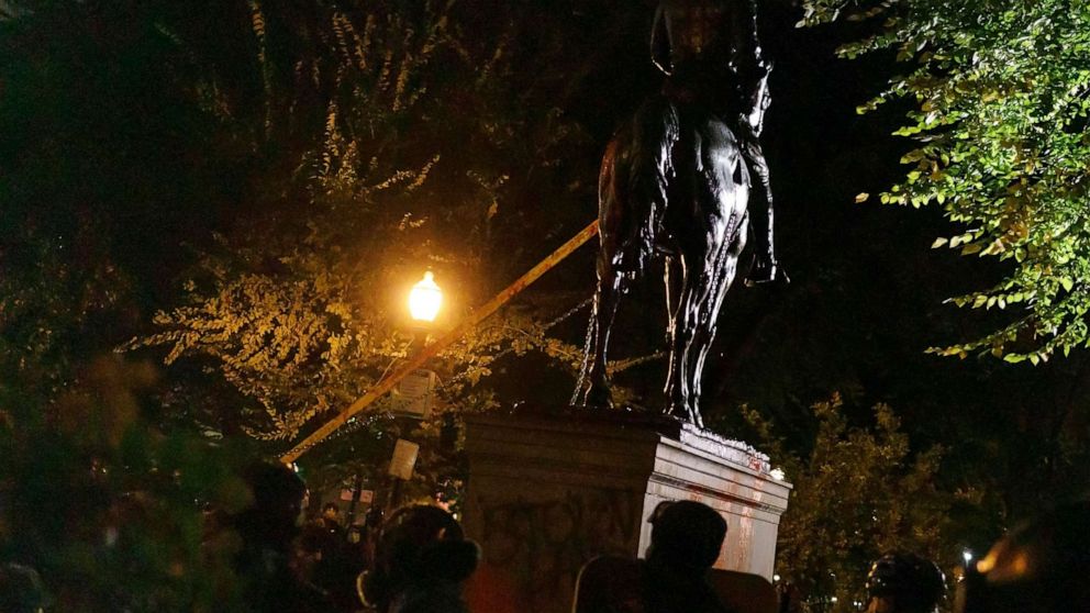 PHOTO: A statue of President Theodore Roosevelt is pulled down by demonstrators protesting white colonialism on a "Day of Rage" march in downtown Portland, Ore., Oct. 11, 2020.