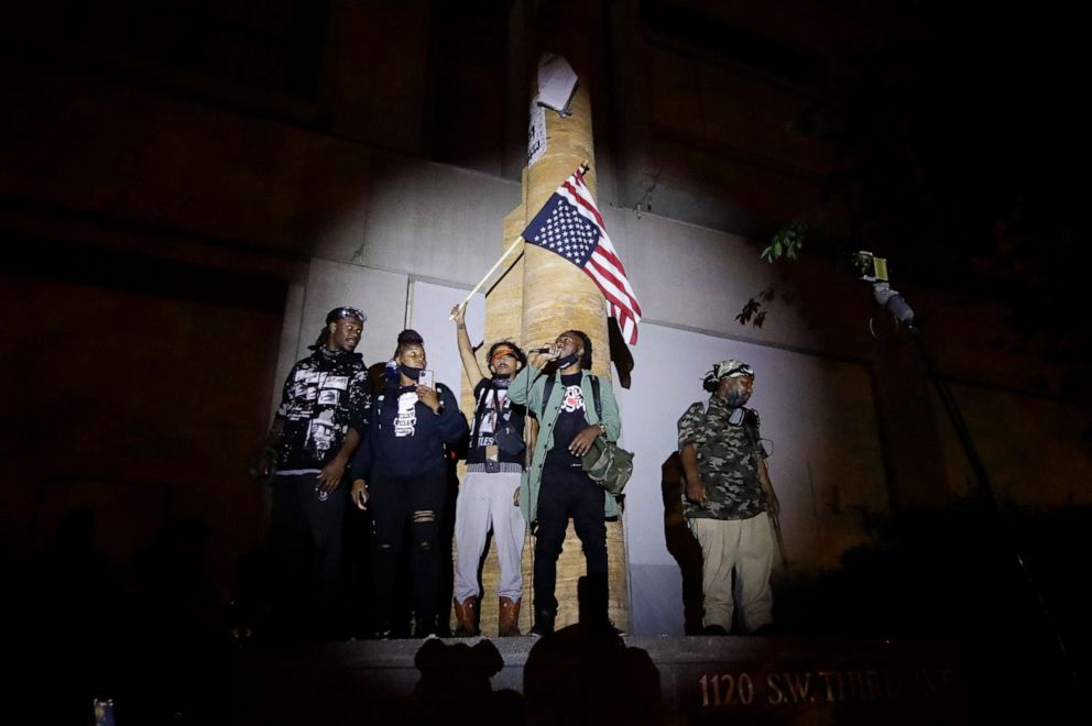 PHOTO: A group of demonstrators addresses the crowd during a Black Lives Matter protest at the Mark O. Hatfield United States Courthouse, July 23, 2020, in Portland, Ore.