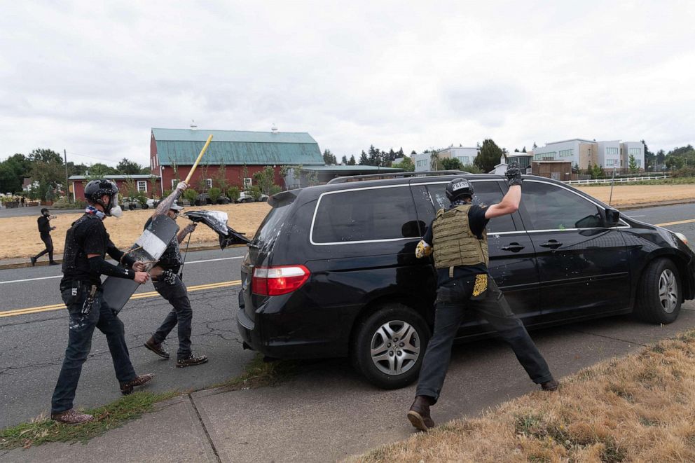 PHOTO: Members of the Proud Boys attack a van during a clash with anti-fascist activists following a far-right rally, Aug. 22, 2021, in Portland, Ore.