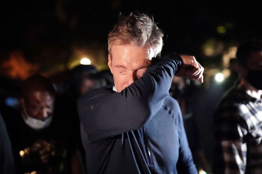 PHOTO: Portland Mayor Ted Wheeler reacts after being exposed to tear gas fired by federal officers while attending a protest against police brutality and racial injustice in front of the Mark O. Hatfield U.S. Courthouse, July 22, 2020 in Portland, Ore.