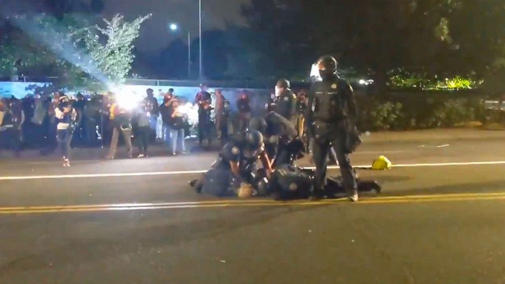 PHOTO: Portland police officers were video recorded on Aug. 30, 2020, repeatedly punching a protester being held down on a street.